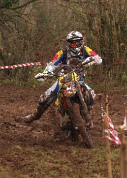 Red Bull clothed rider in the mud