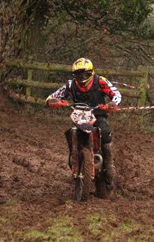 KTM rider guns the throttle in mud