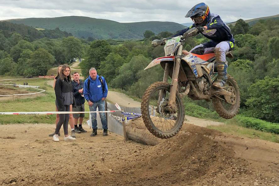 Pic of Roan Delaney jumping over a log at EnduroGP Wales.